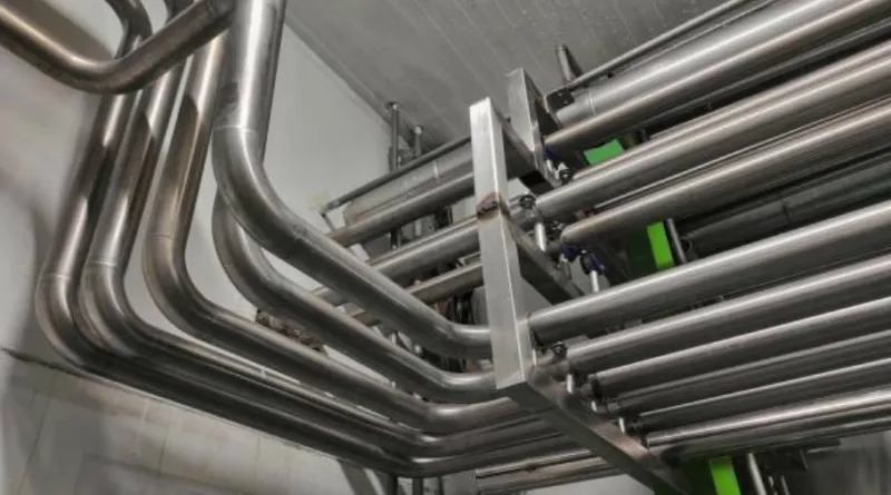 An image of multiple curved industrial pipes.